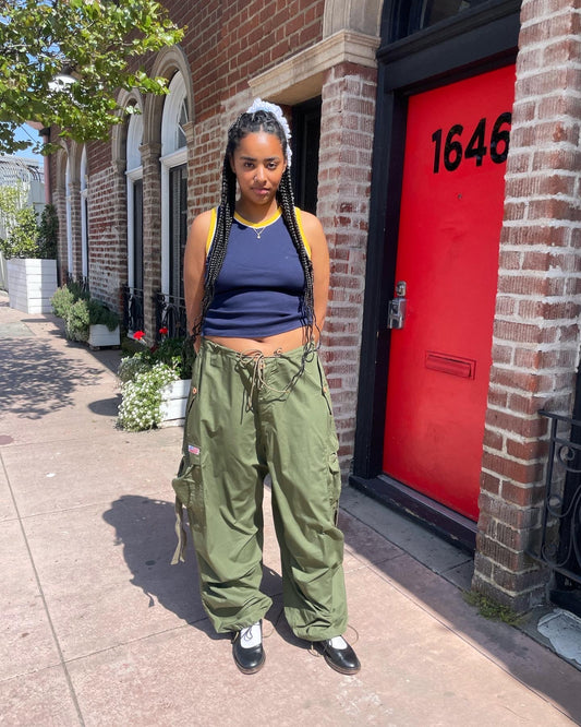 girl wearing blue tank top and baggy green cargo pants
