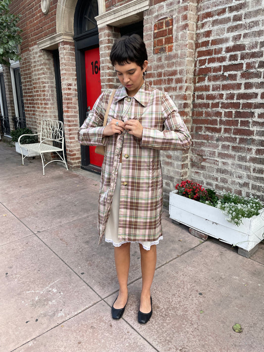 girl wearing plaid trench coat