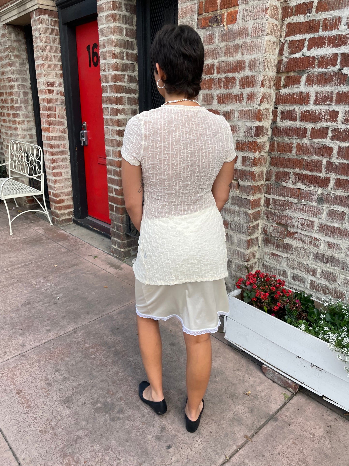 girl in white top and sheer white skirt