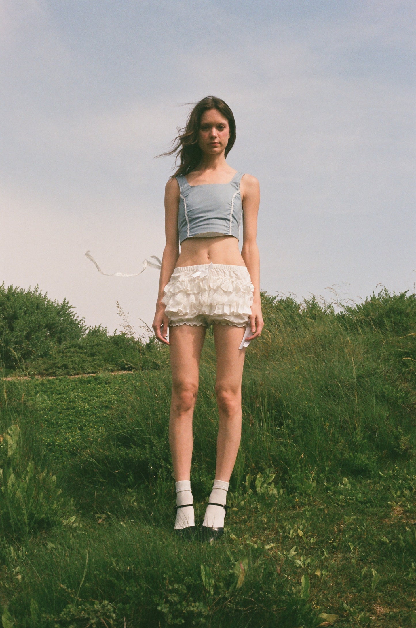 girl wearing blue corset and white bloomers