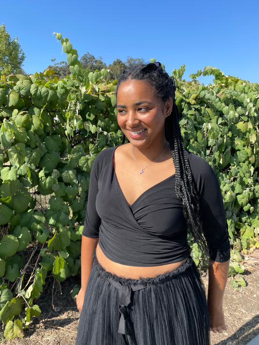 girl wearing black wrap top