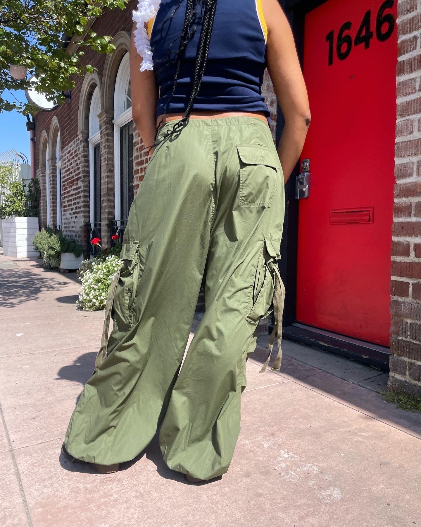 girl wearing blue tank top and baggy green cargo pants
