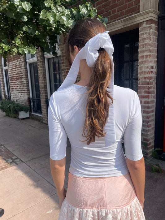girl in white top and pink skirt