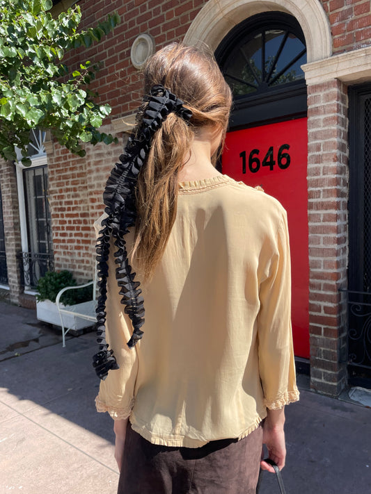 girl in yellow button up and brown skirt