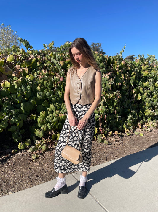 girl in brown leather vest