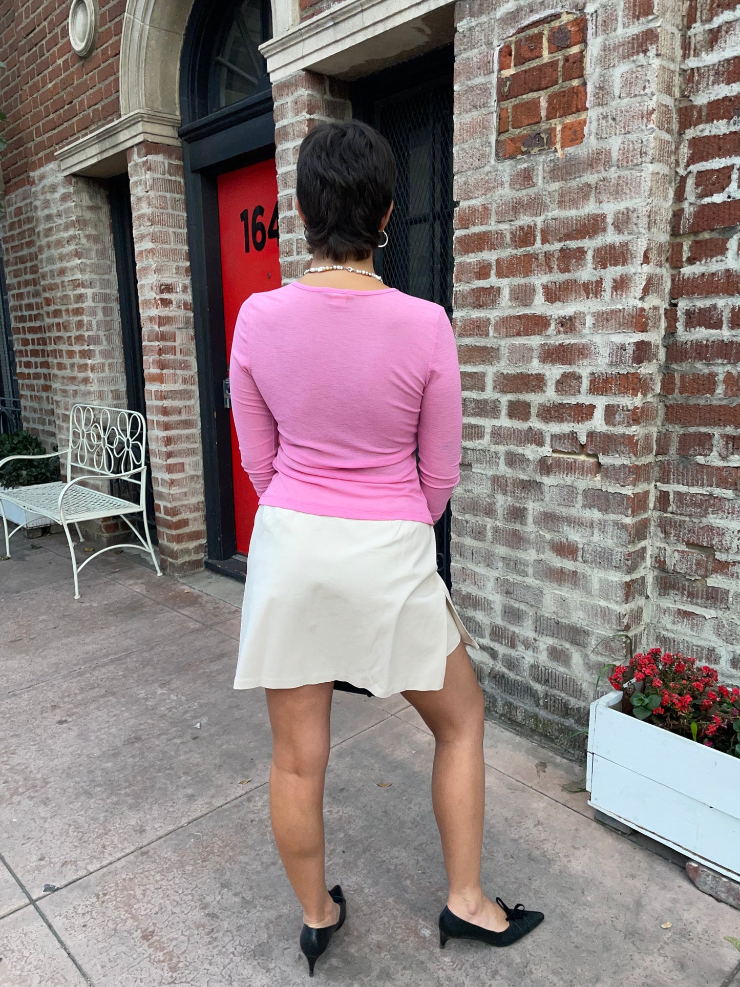 girl in pink top and cream skirt