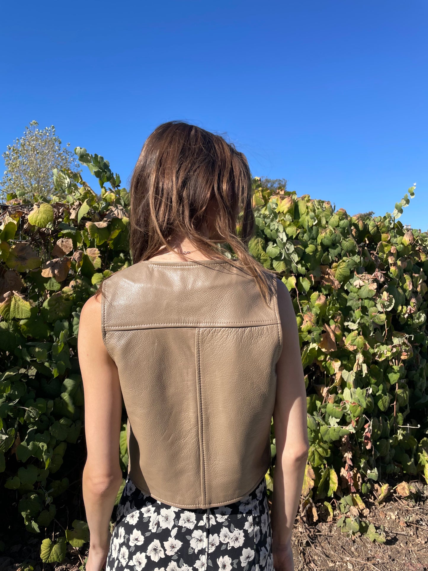 girl in brown leather vest