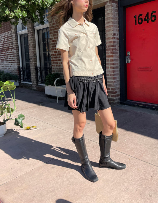 girl in yellow button up and black skirt