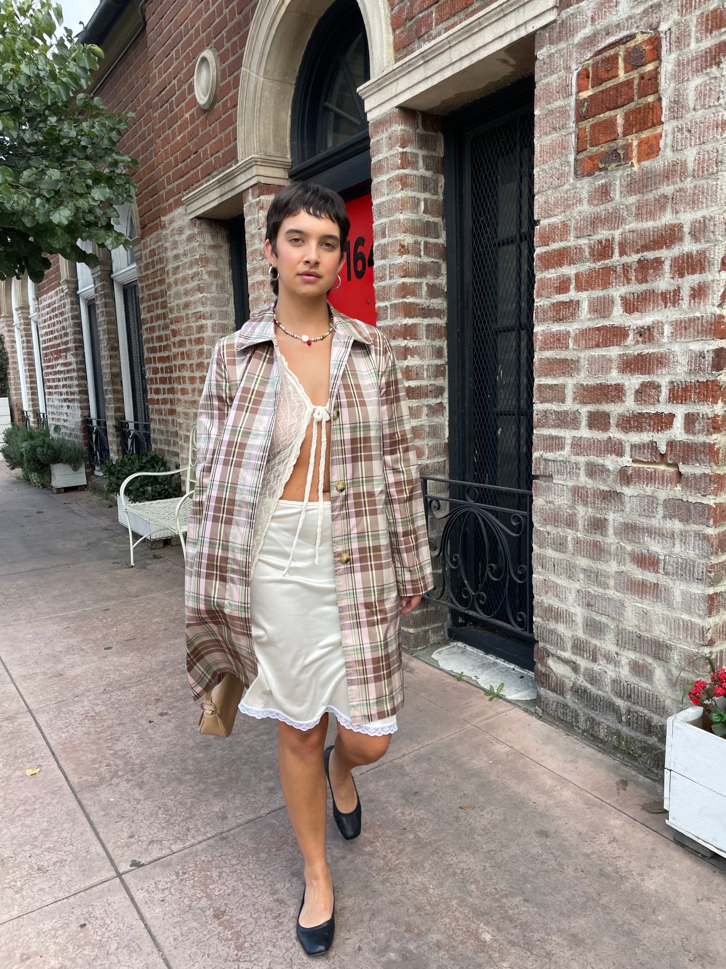 girl wearing plaid trench coat