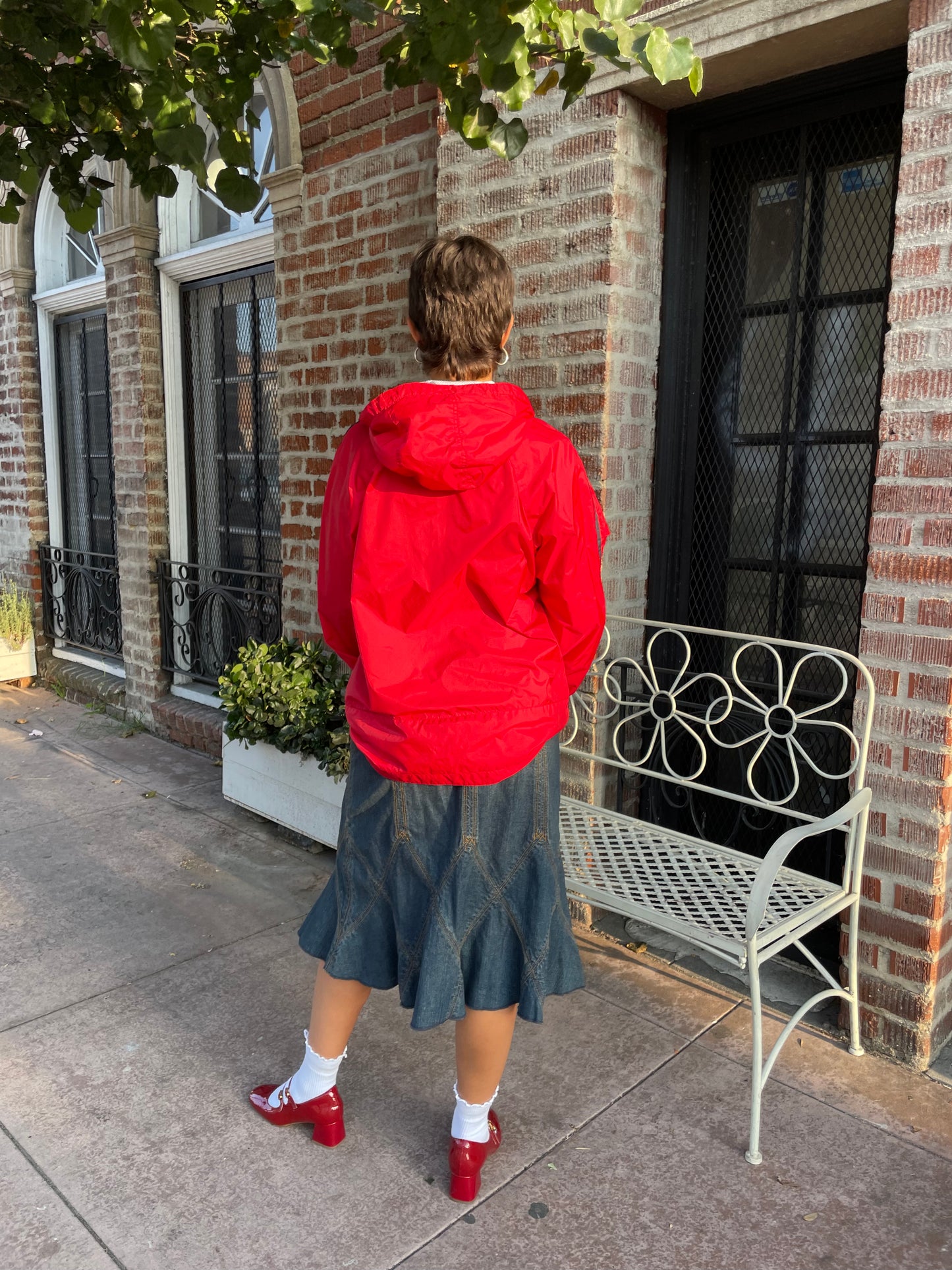 girl in red jacket and denim skirt