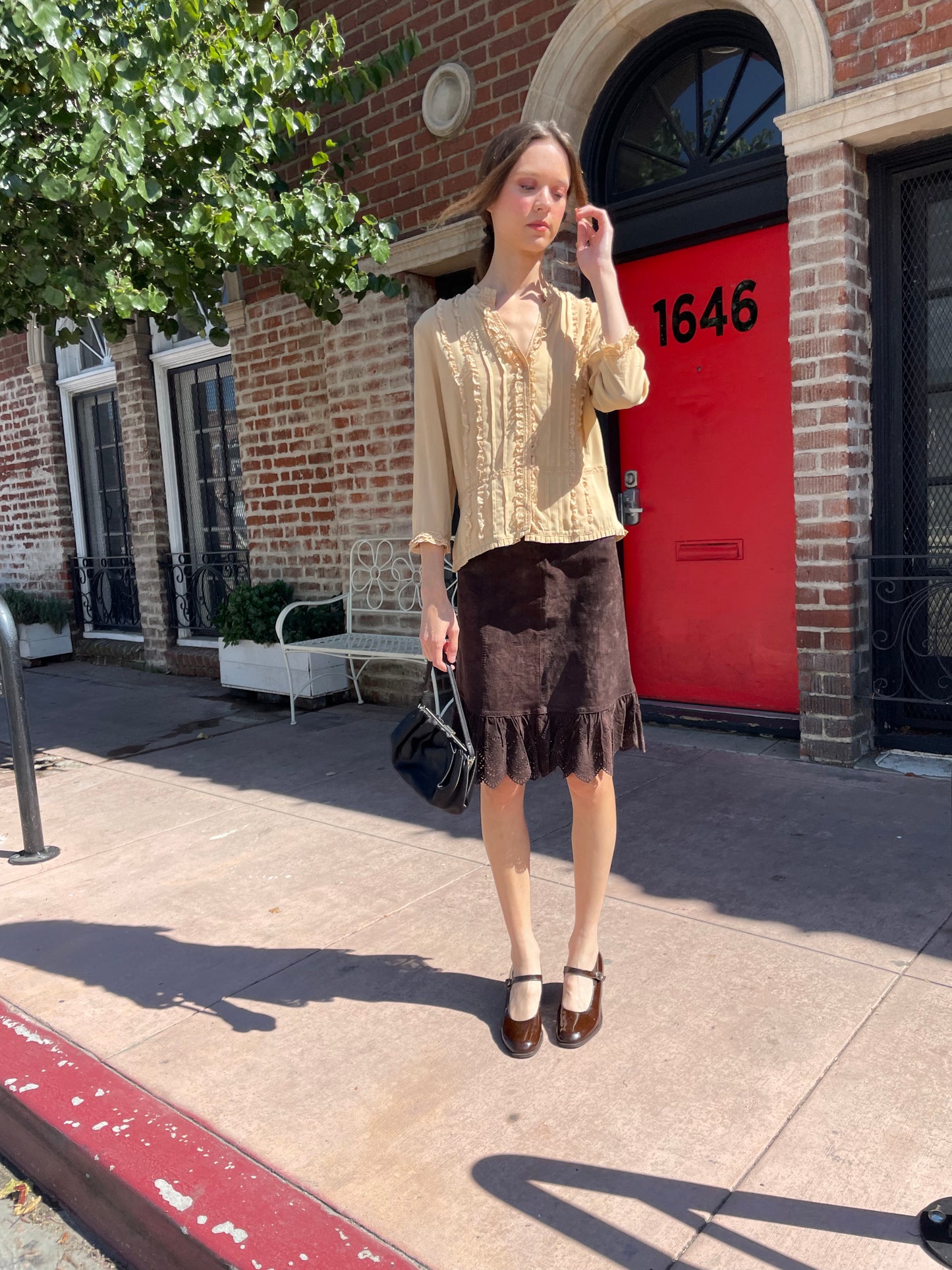 girl in yellow button up and brown skirt