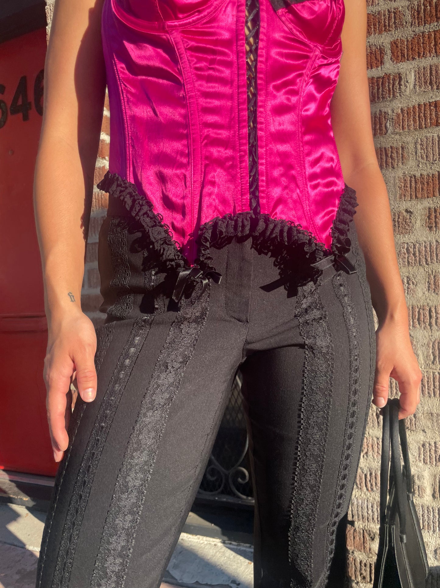 girl wearing black pants and black and red corset