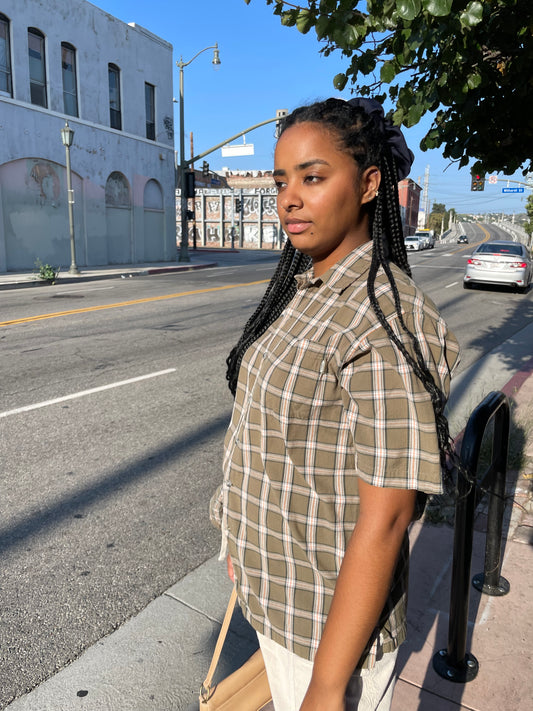 girl in plaid green button up and khaki pants