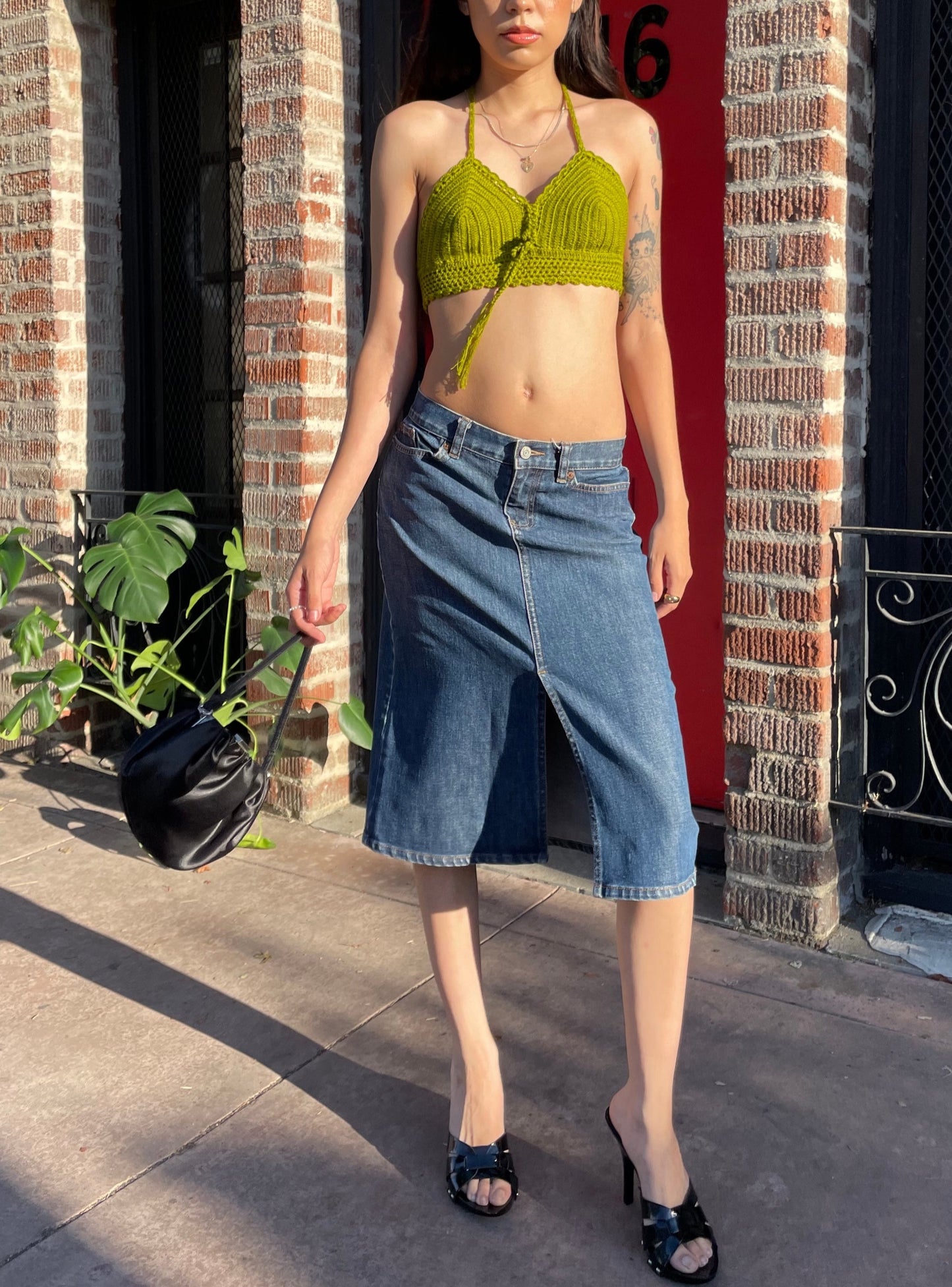 girl in green top and denim skirt