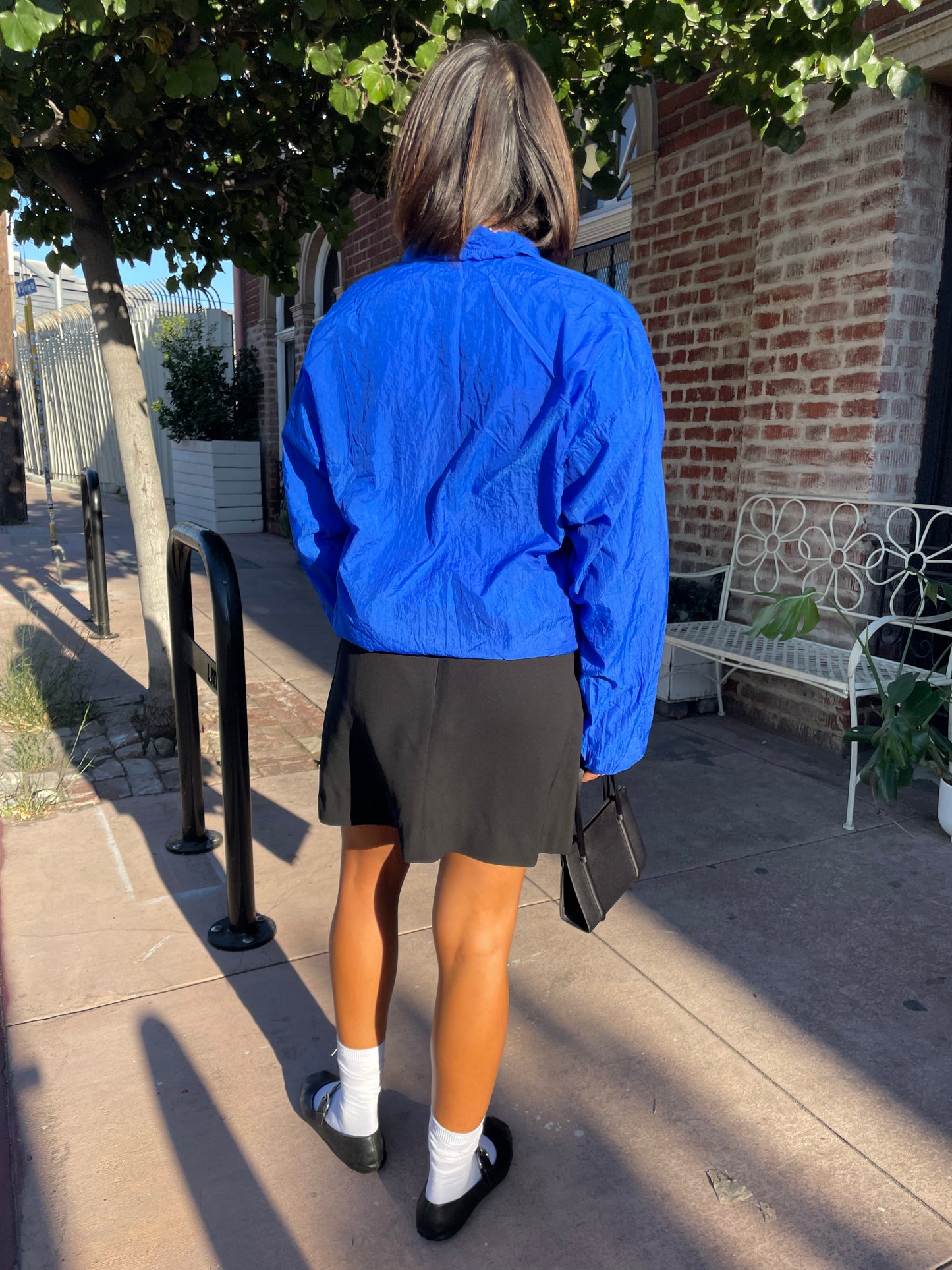 girl in blue jacket and black mini skirt