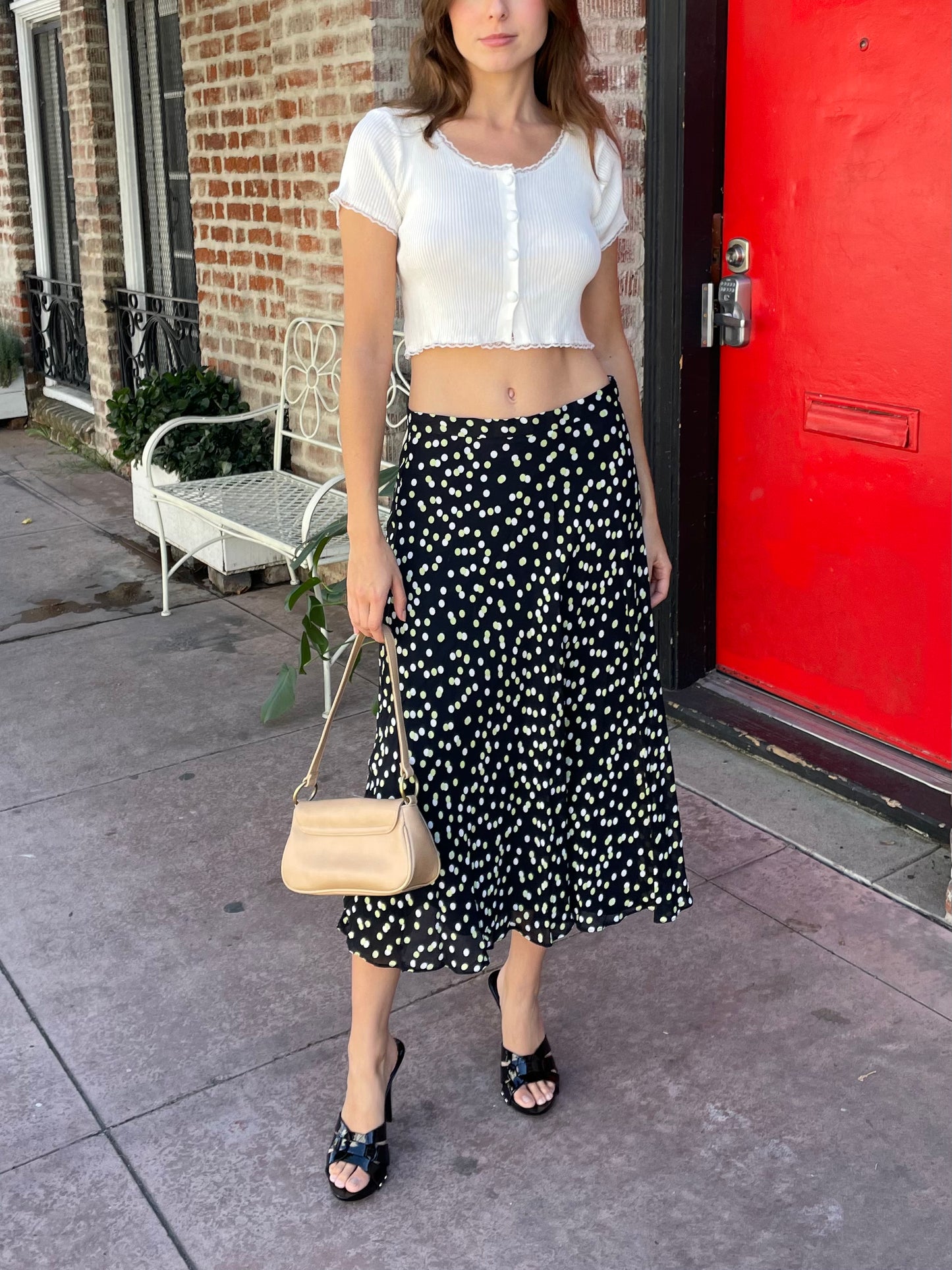 girl in black polka dot dress