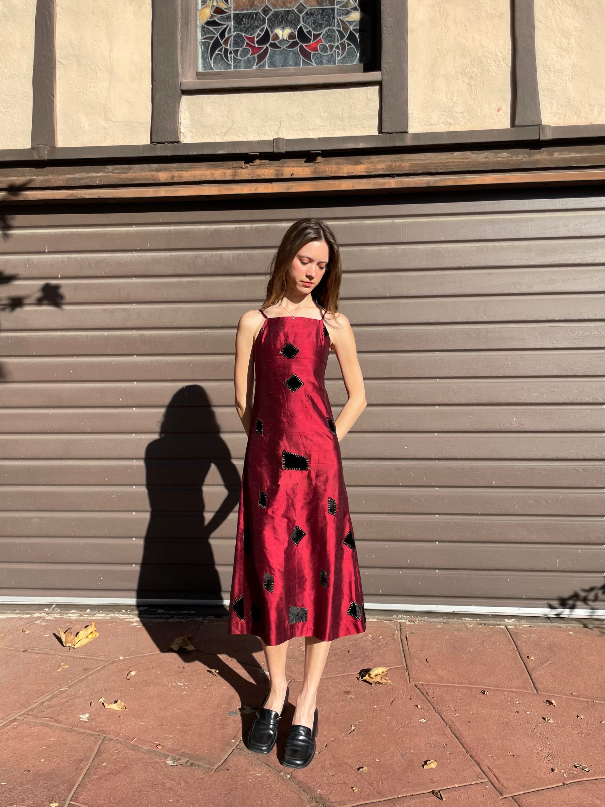 girl in red patchwork dress