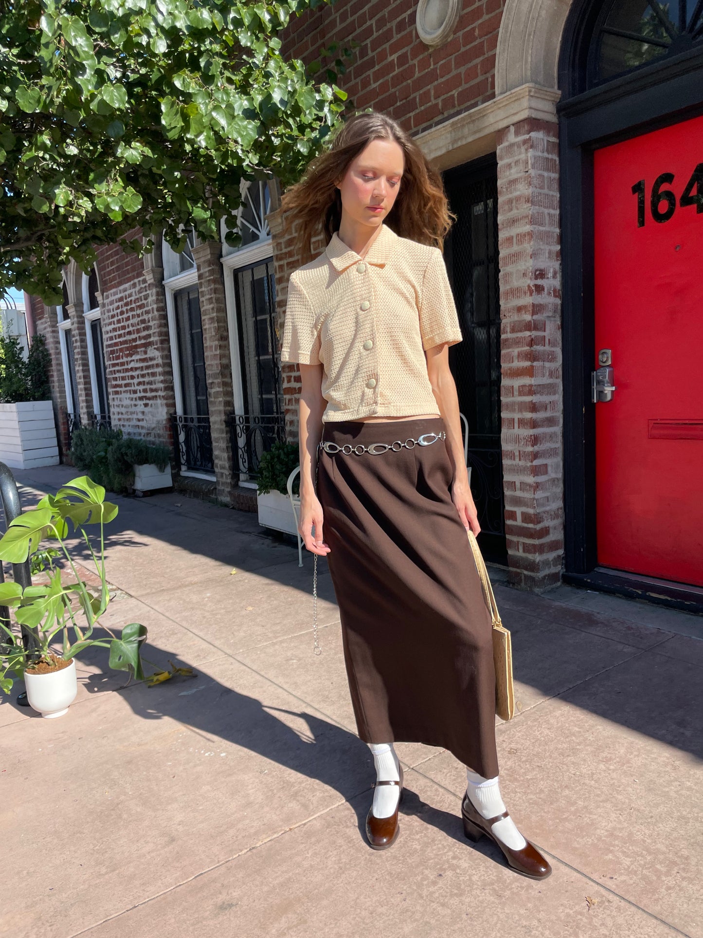 girl in yellow top and brown skirt
