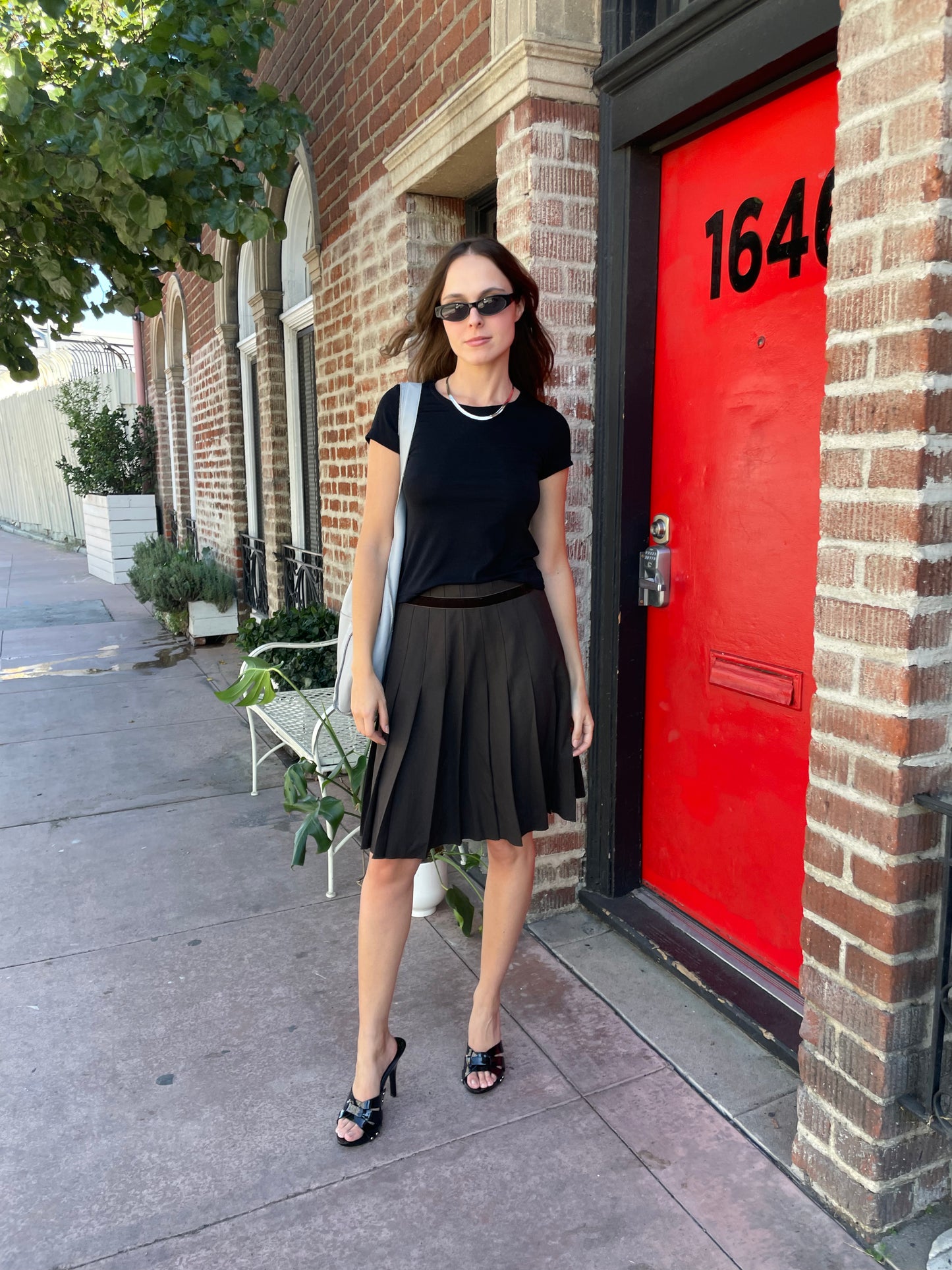 girl in brown pleated skirt