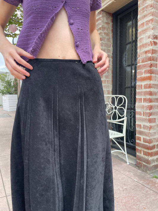 girl wearing purple button up top and long black skirt