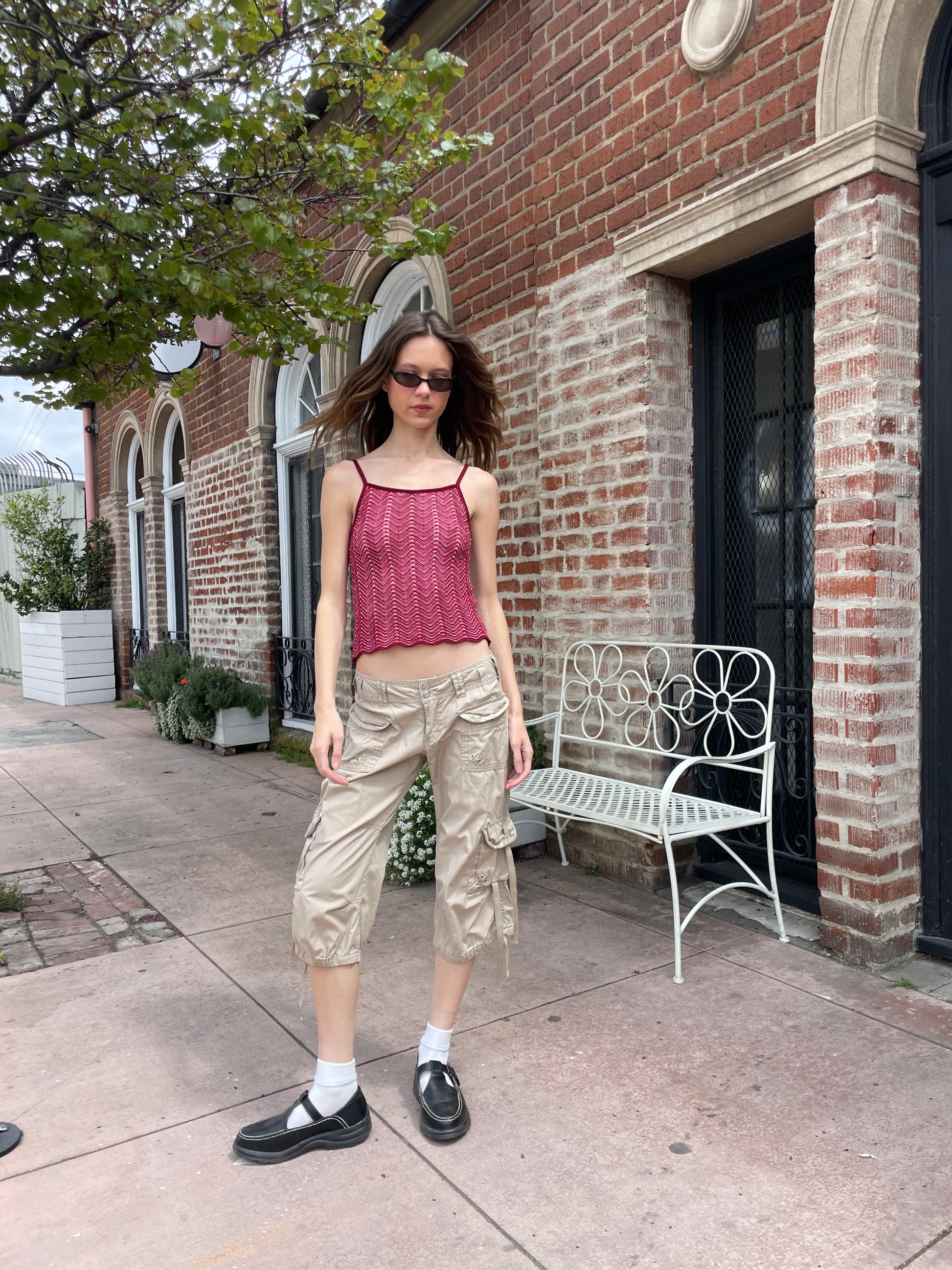 girl wearing red shirt and tan cargo pants