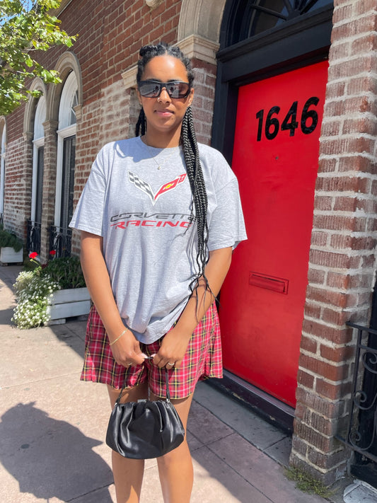 girl wearing vintage corvette shirt and red plaid skirt