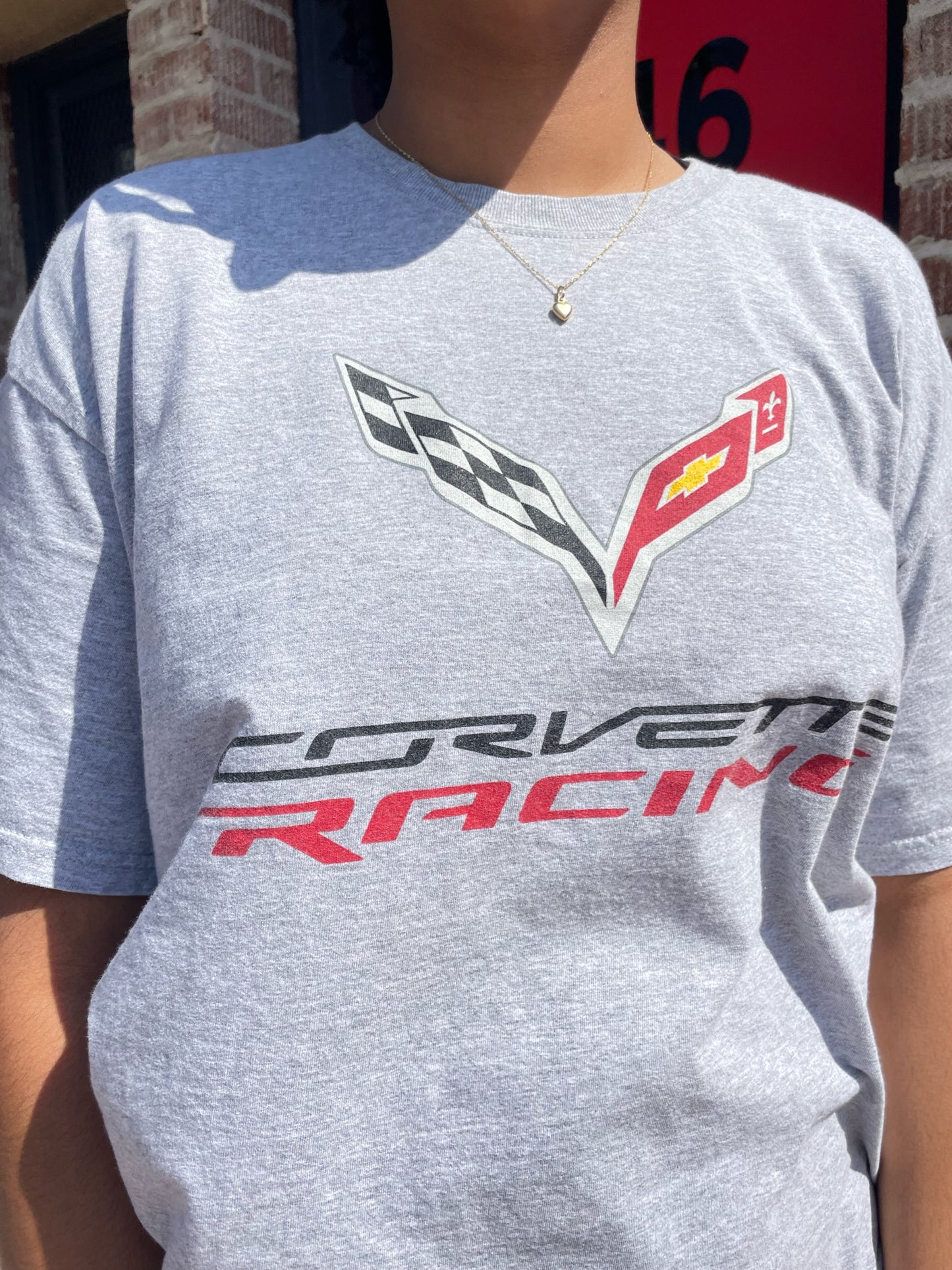 girl wearing vintage corvette shirt and red plaid skirt