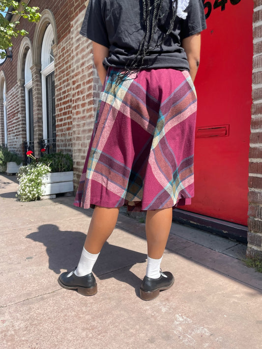 girl wearing a black t shirt and red skirt