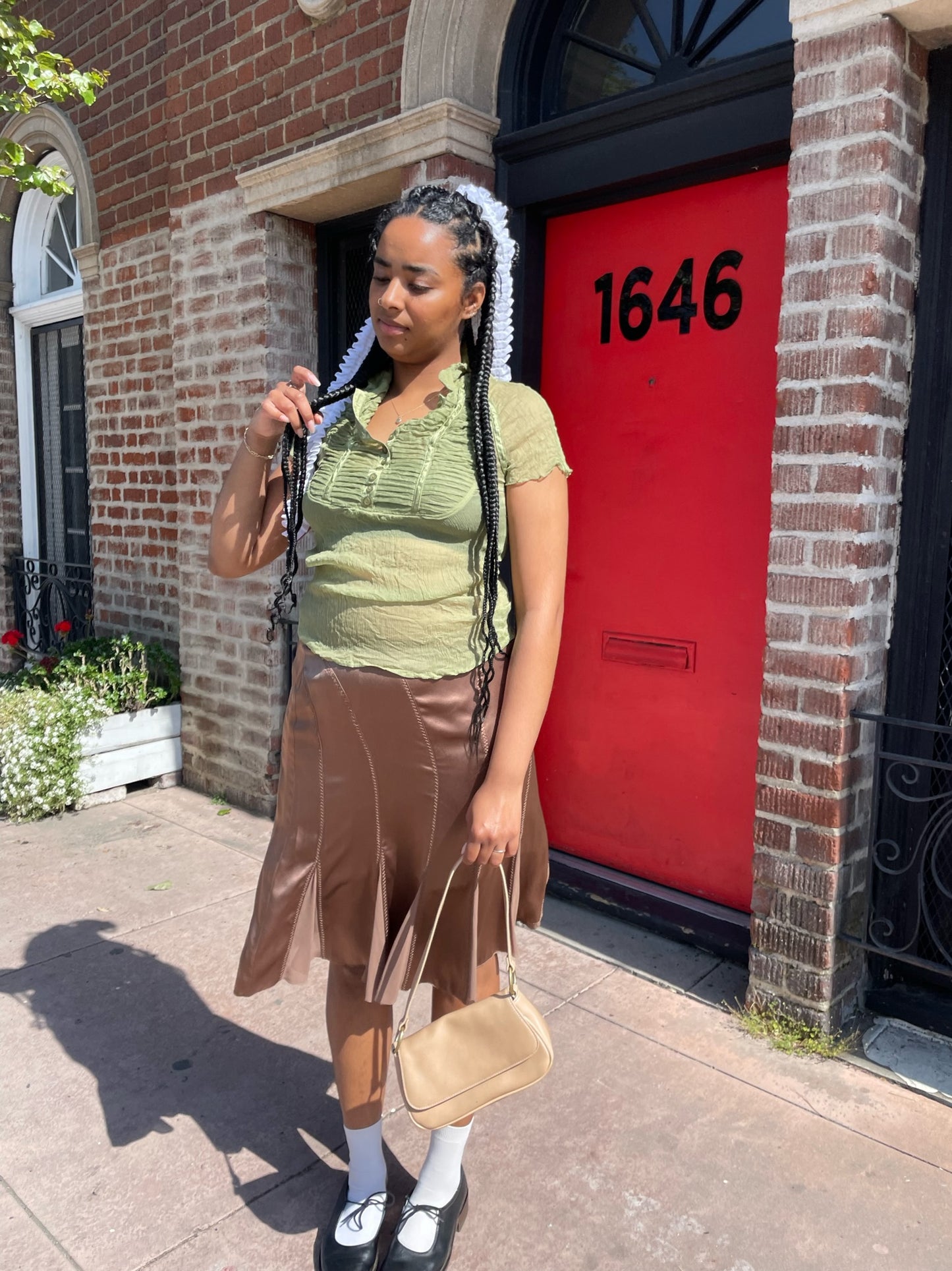 girl wearing green top and pink silk skirt