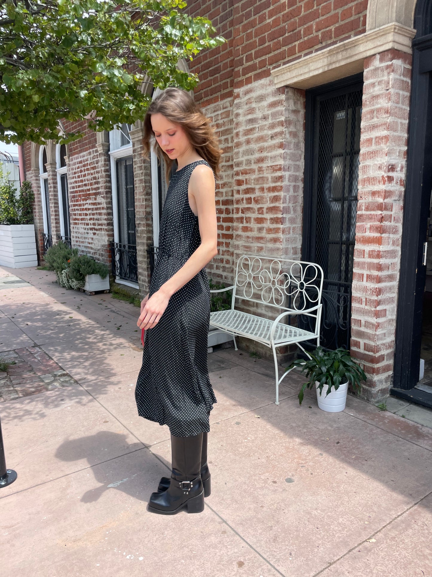 profile of girl wearing black dress and black boots
