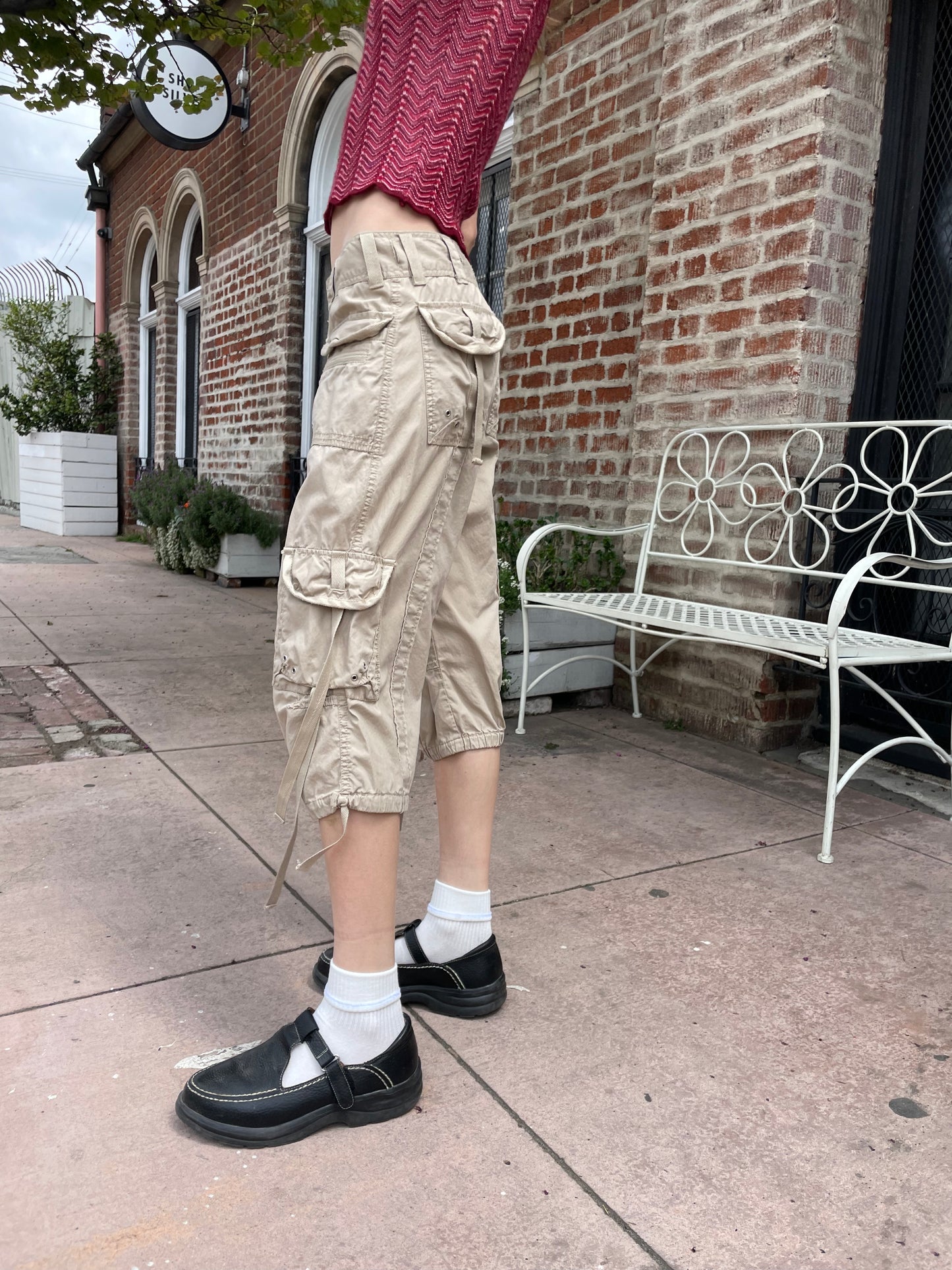 girl wearing red shirt and tan cargo pants