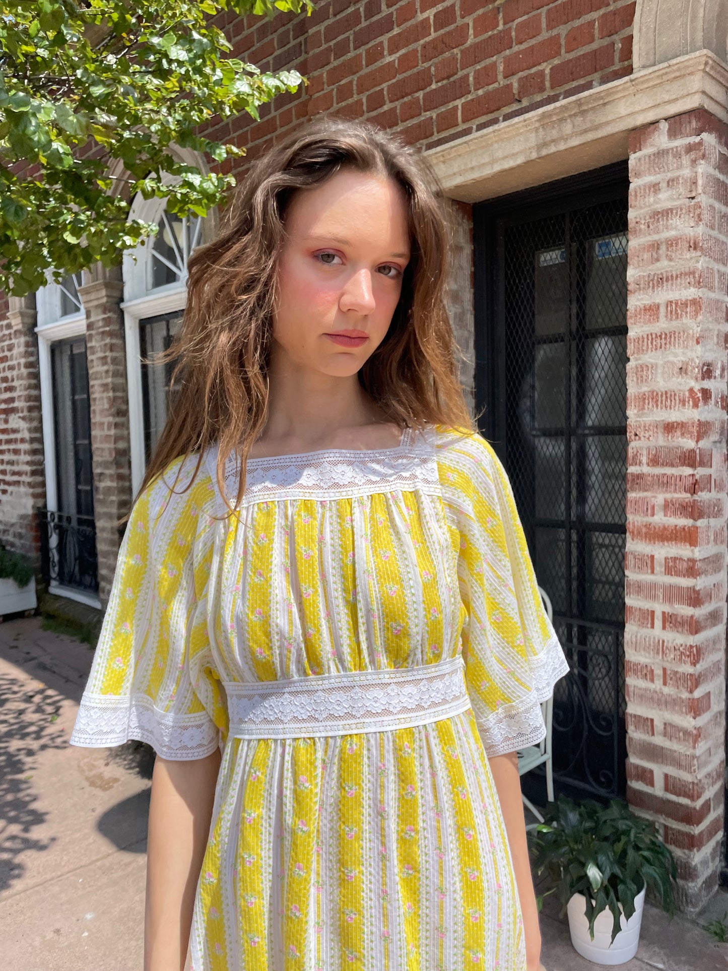 girl wearing long yellow and lace dress