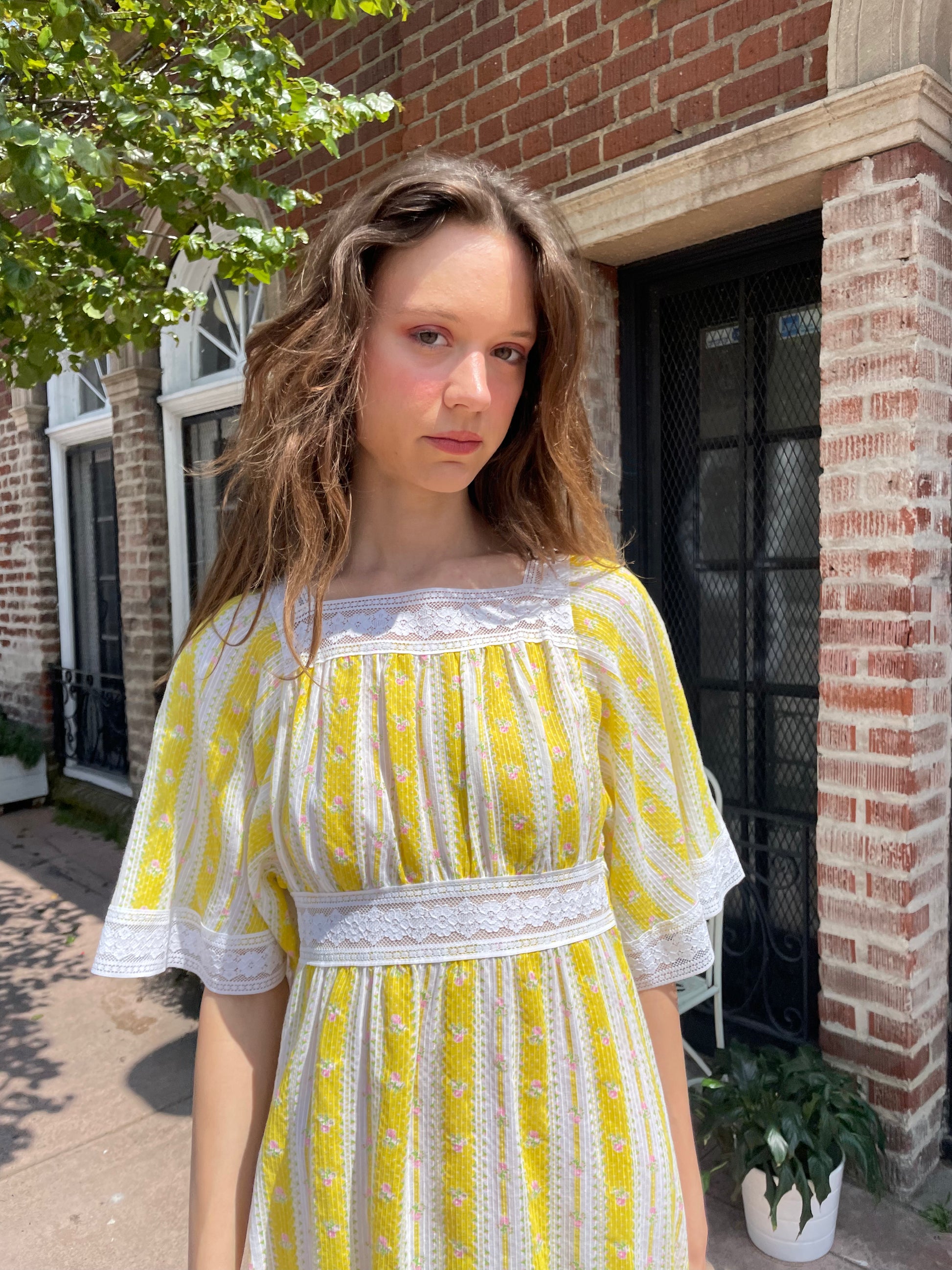 girl wearing long yellow and lace dress