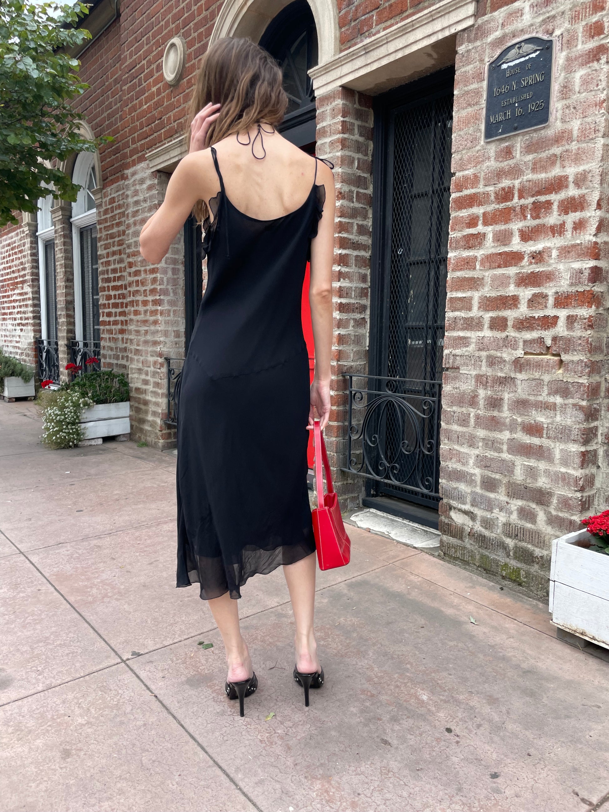 girl in black skinny strap dress