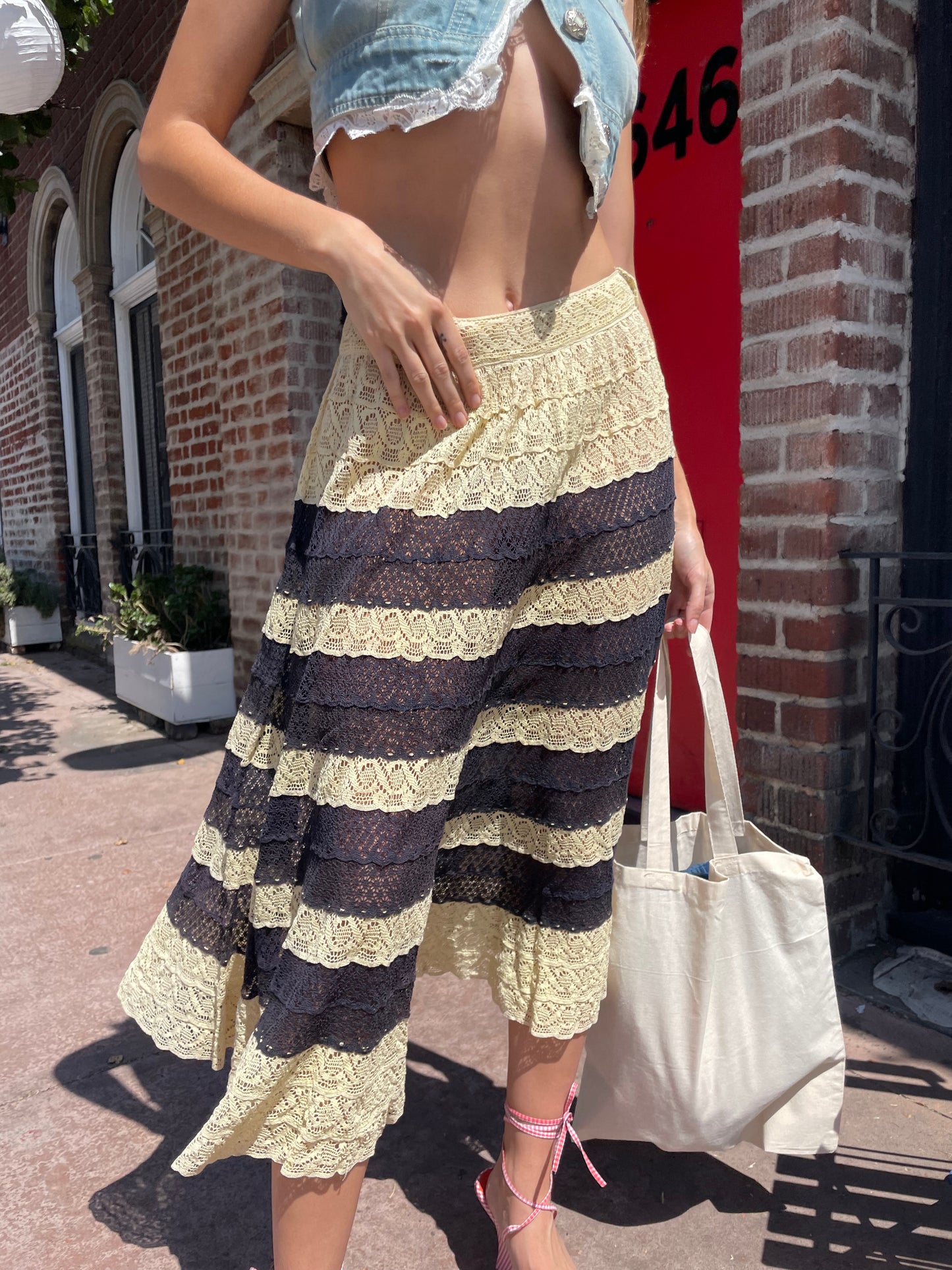 girl in denim top and blue and yellow lace skirt