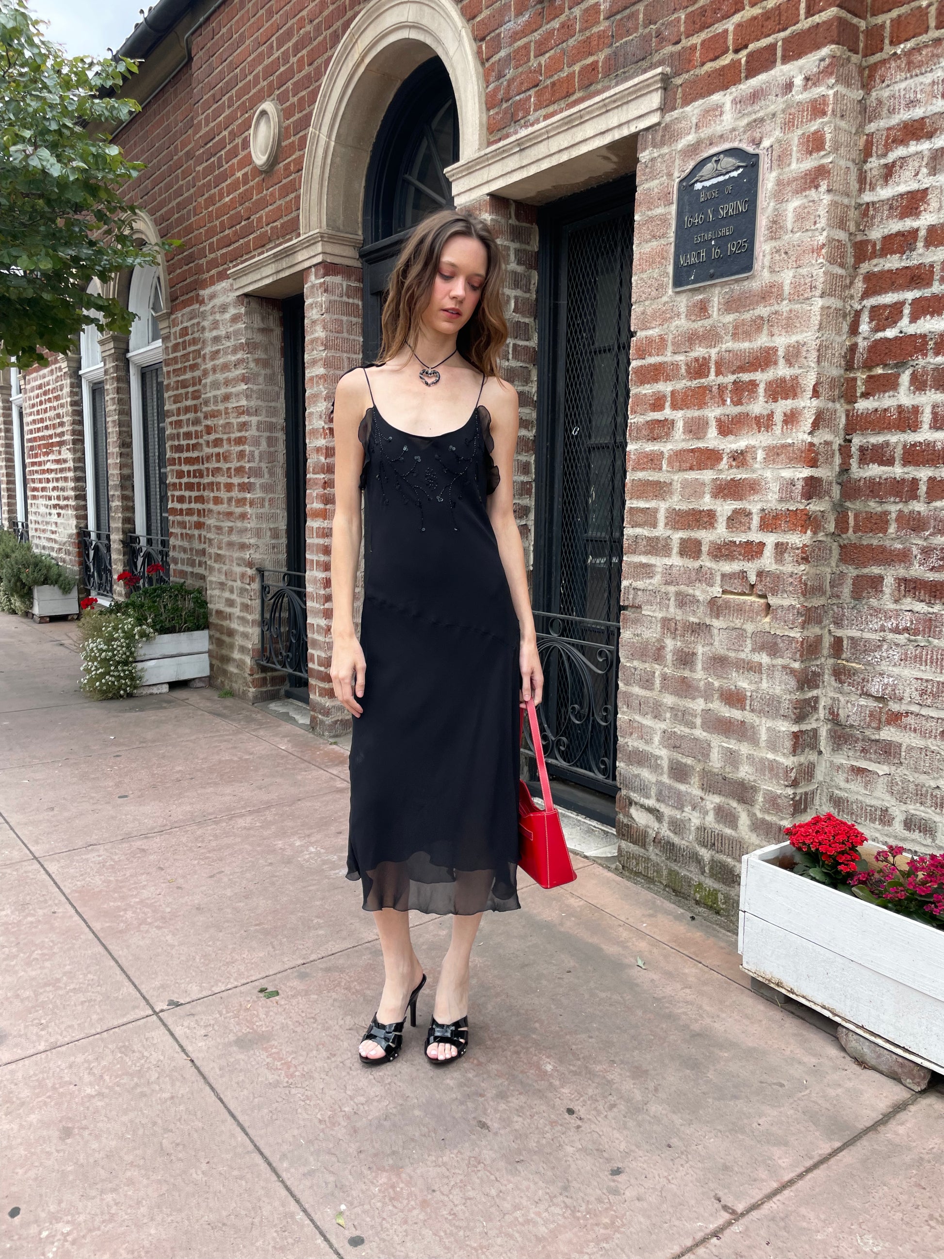 girl in black skinny strap dress