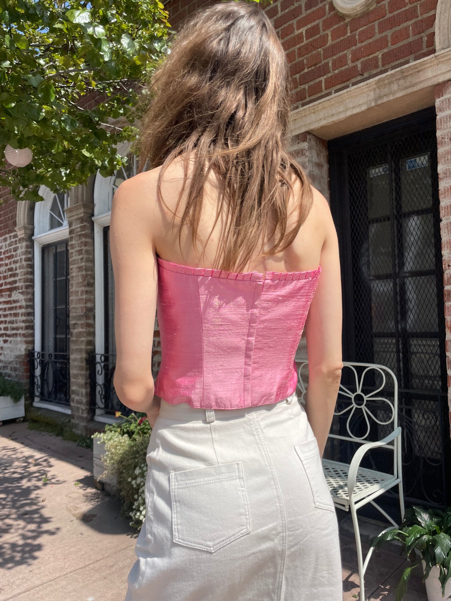 back of girl wearing pink corset