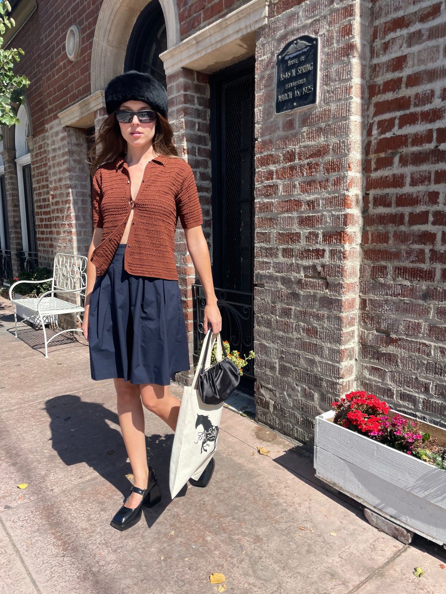girl in navy skirt and orange top