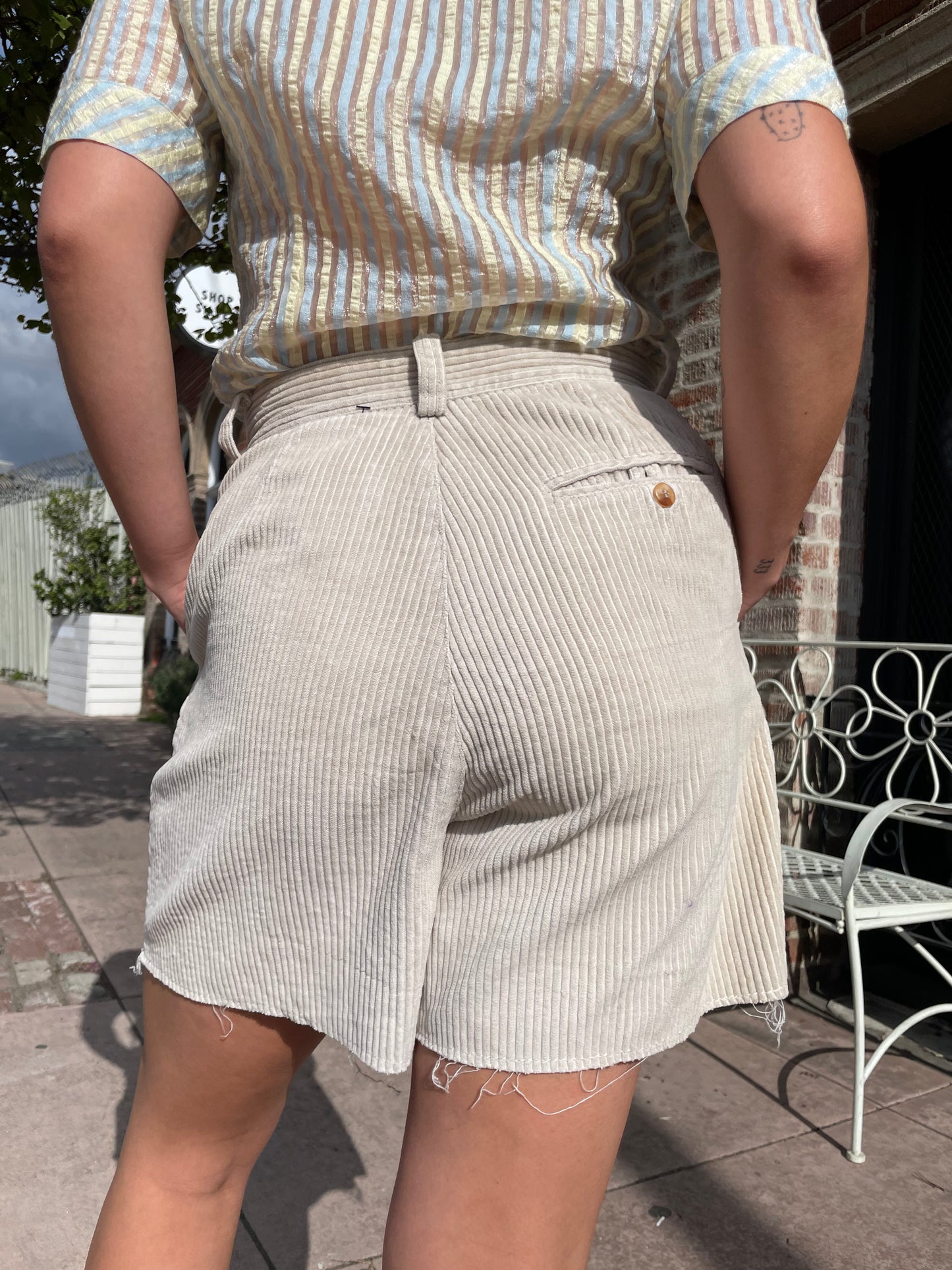 girl wearing tan shirt and shorts