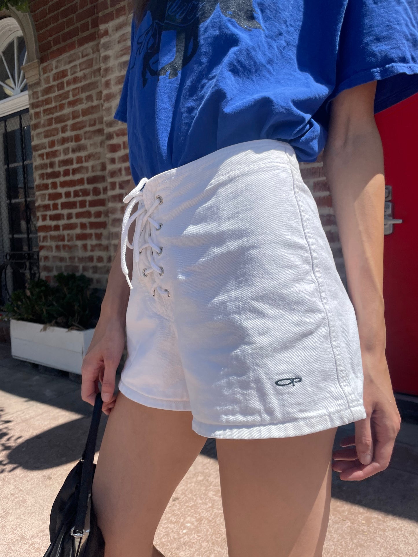 girl in white shorts and blue t-shirt