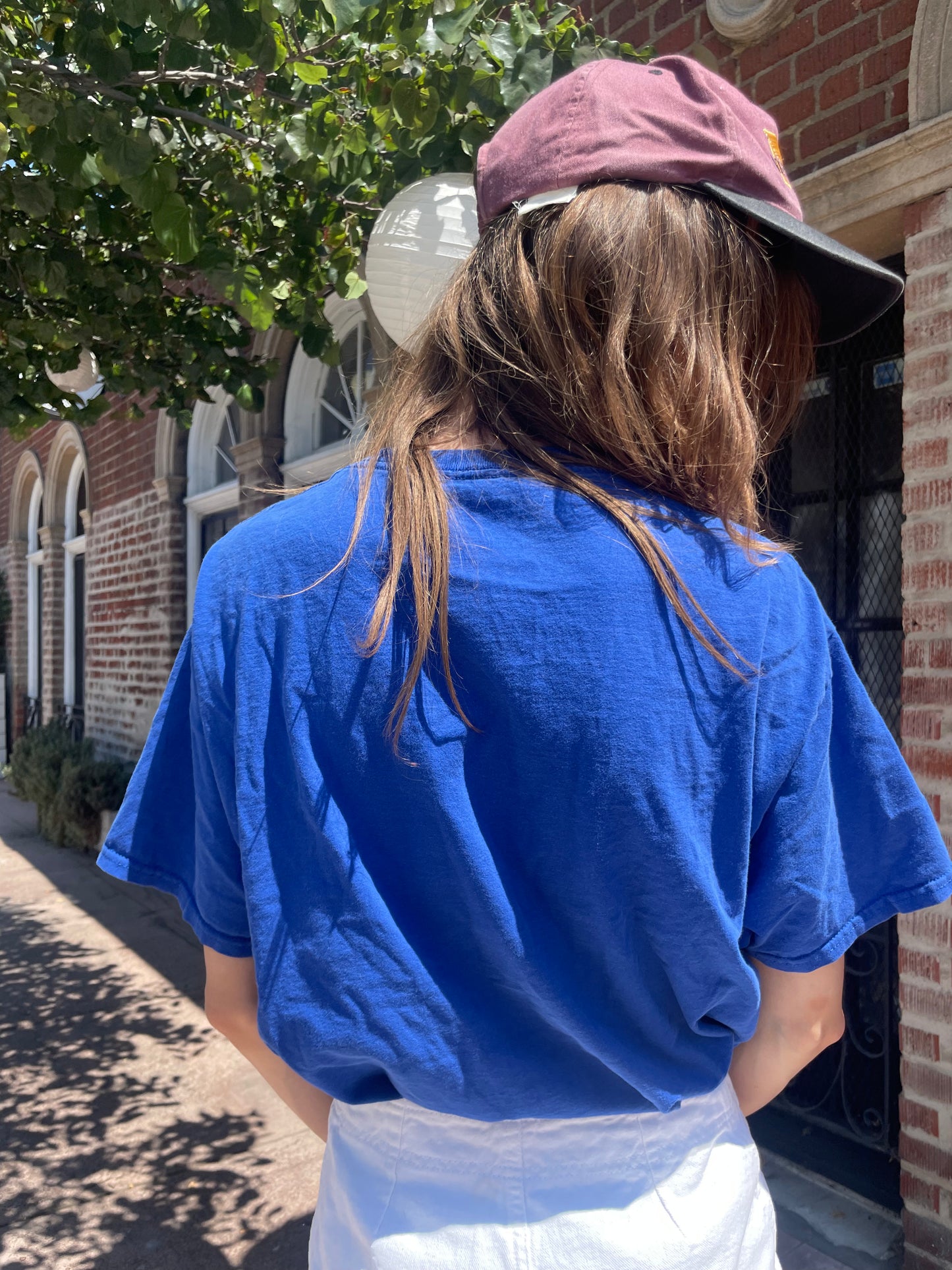 girl in navy shirt and white shorts