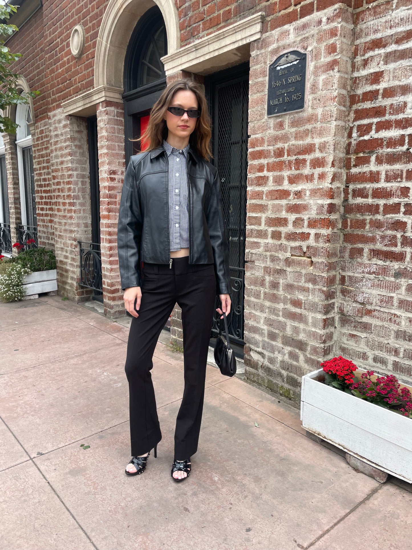 girl wearing leather jacket and black pants