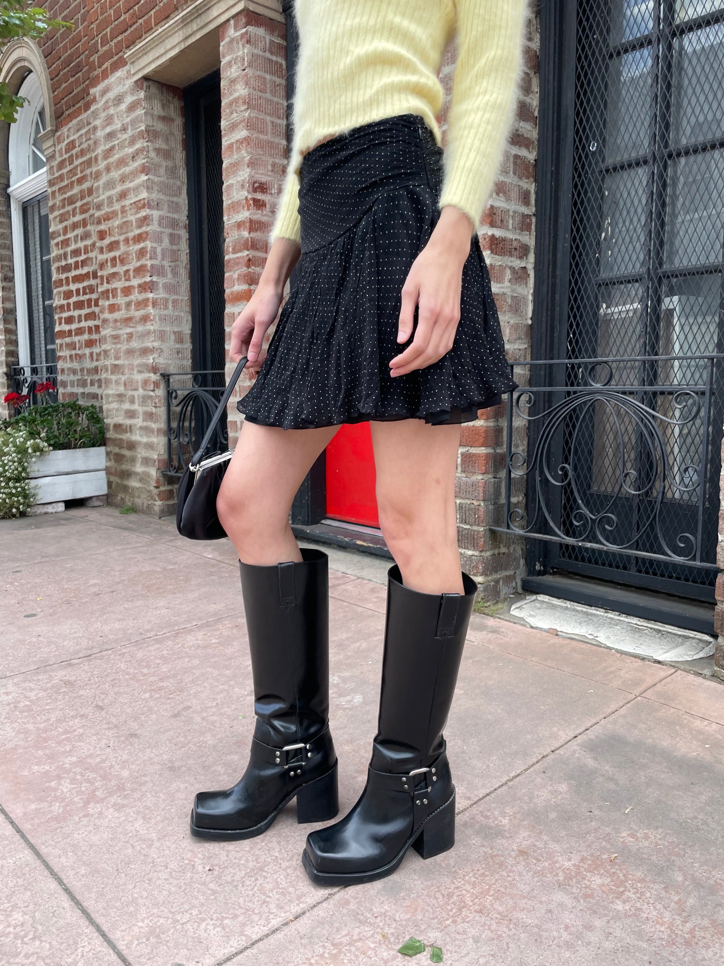 girl wearing yellow sweater and black skirt