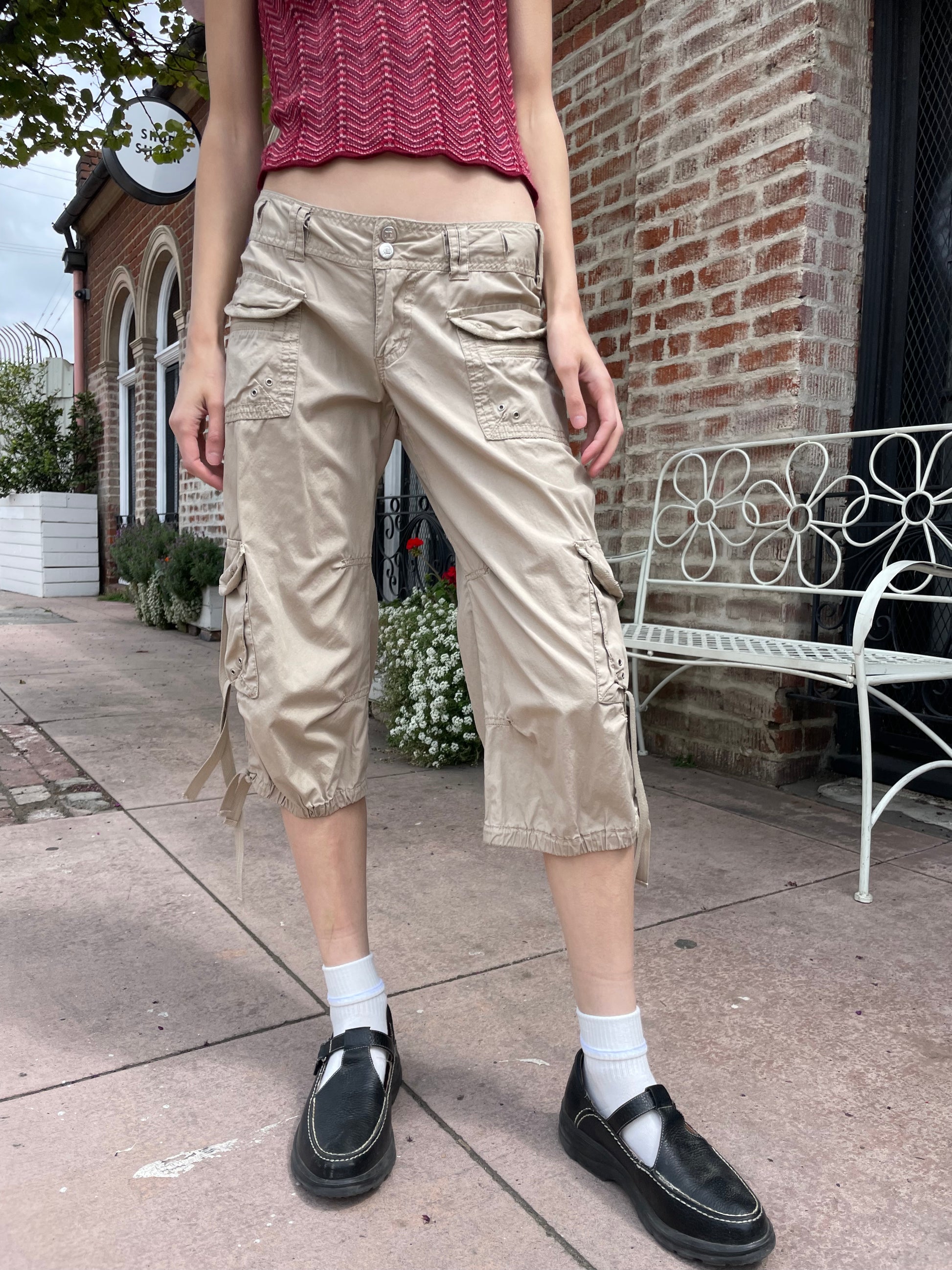 girl wearing red shirt and tan cargo pants