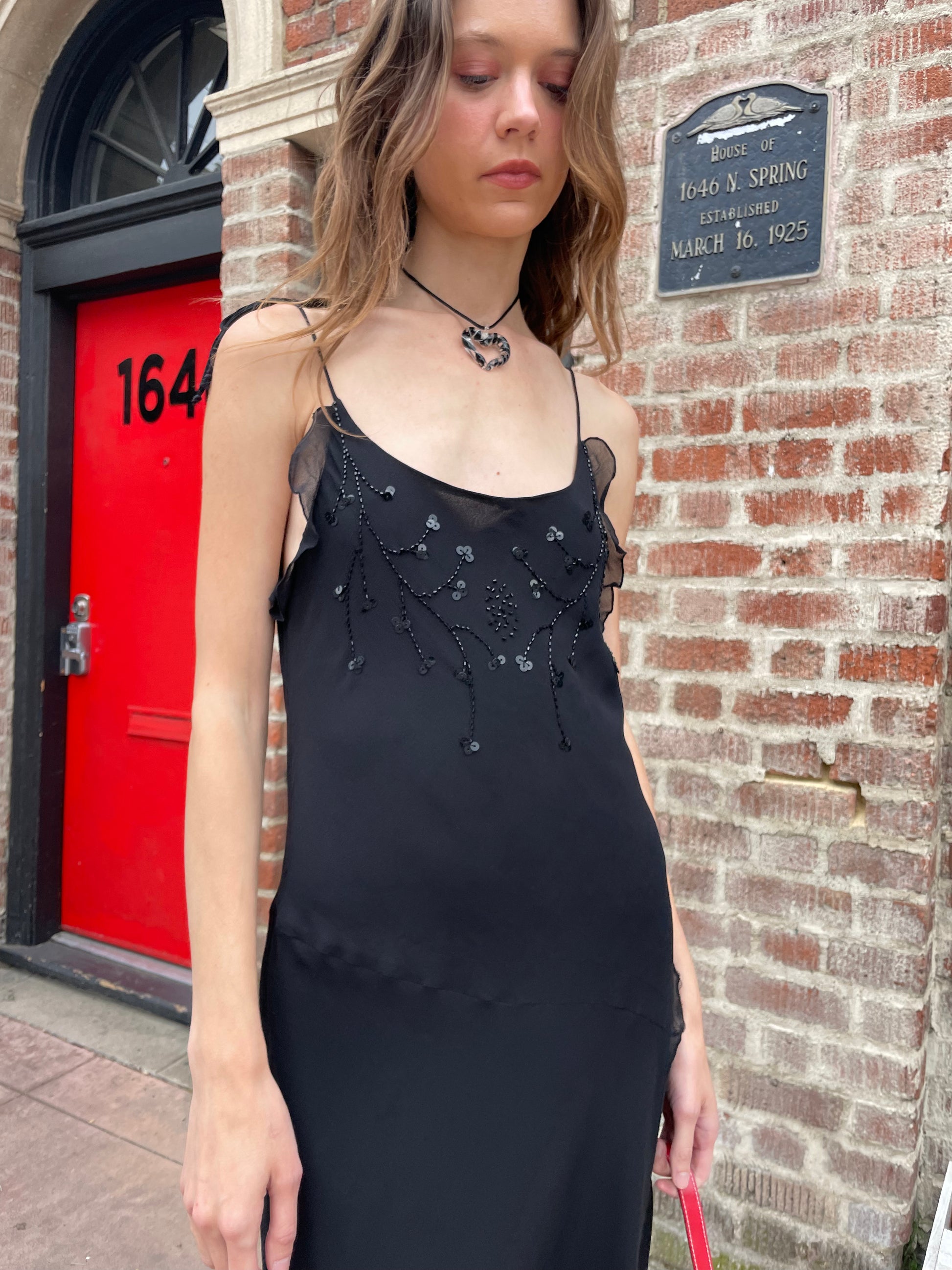 girl in black skinny strap dress