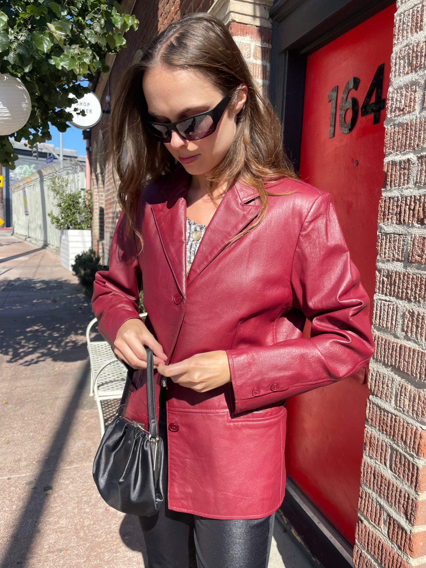 girl in red leather jacket and black leather pants