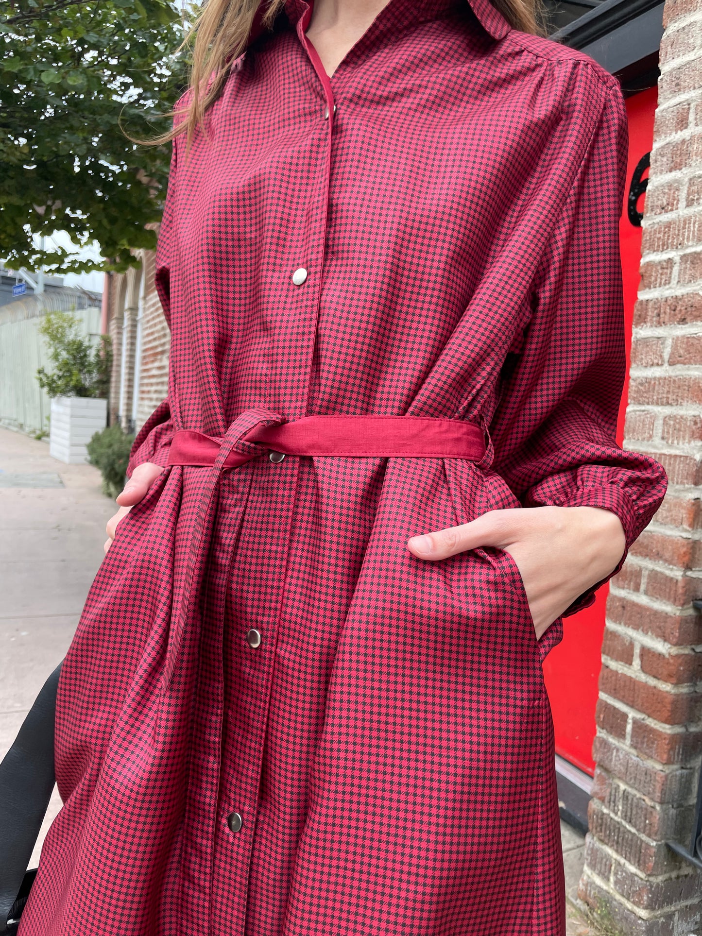 girl in red and black trench