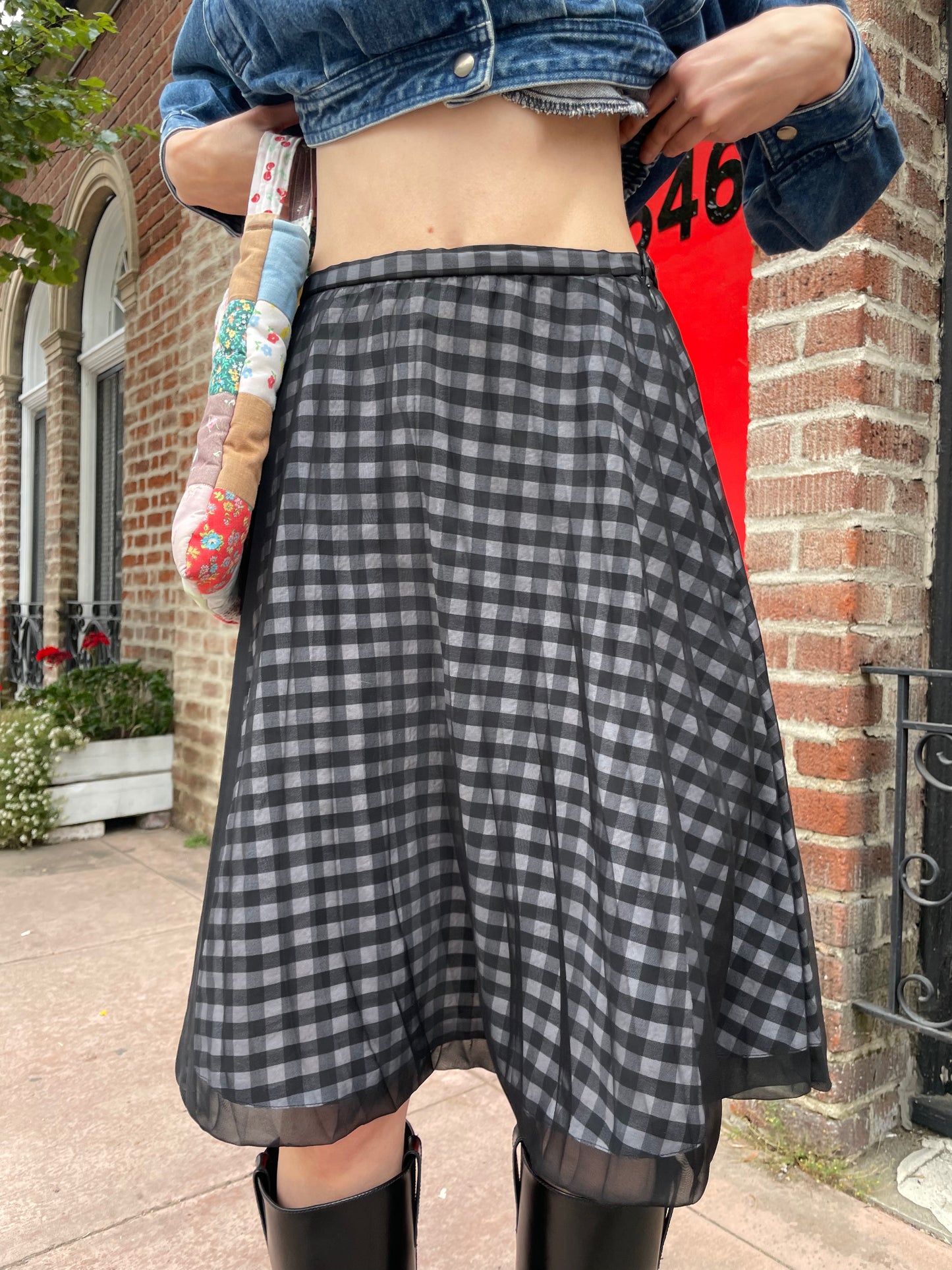 girl wearing denim jacket and gingham skirt