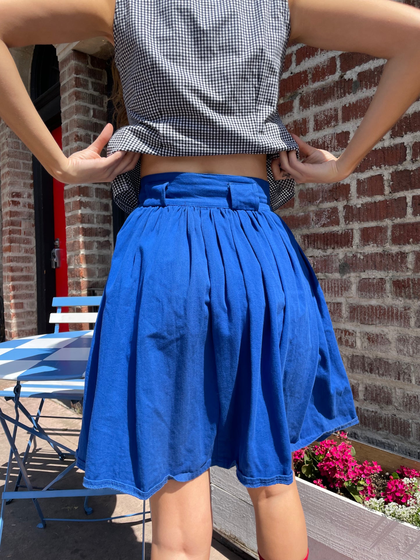 girl in blue skirt and gingham top