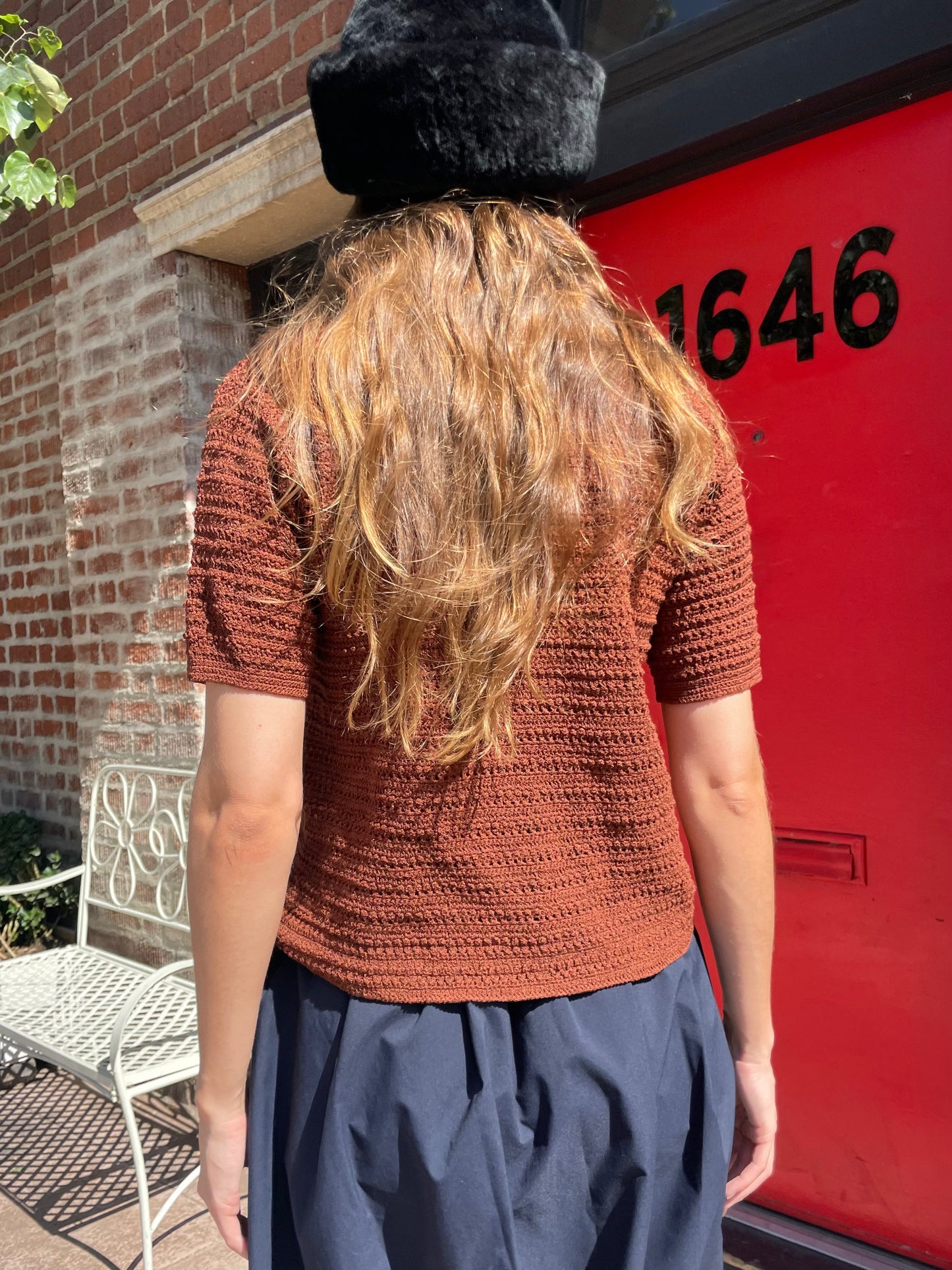 girl in navy skirt and brown button up
